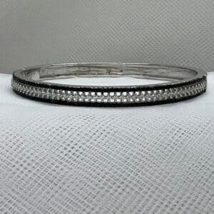 Esclava de plata con circonitas blancas y negras rodidada en oro blanco