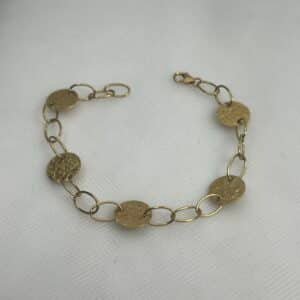 Pulsera de oro amarillo co circulos martelados y eslabones.