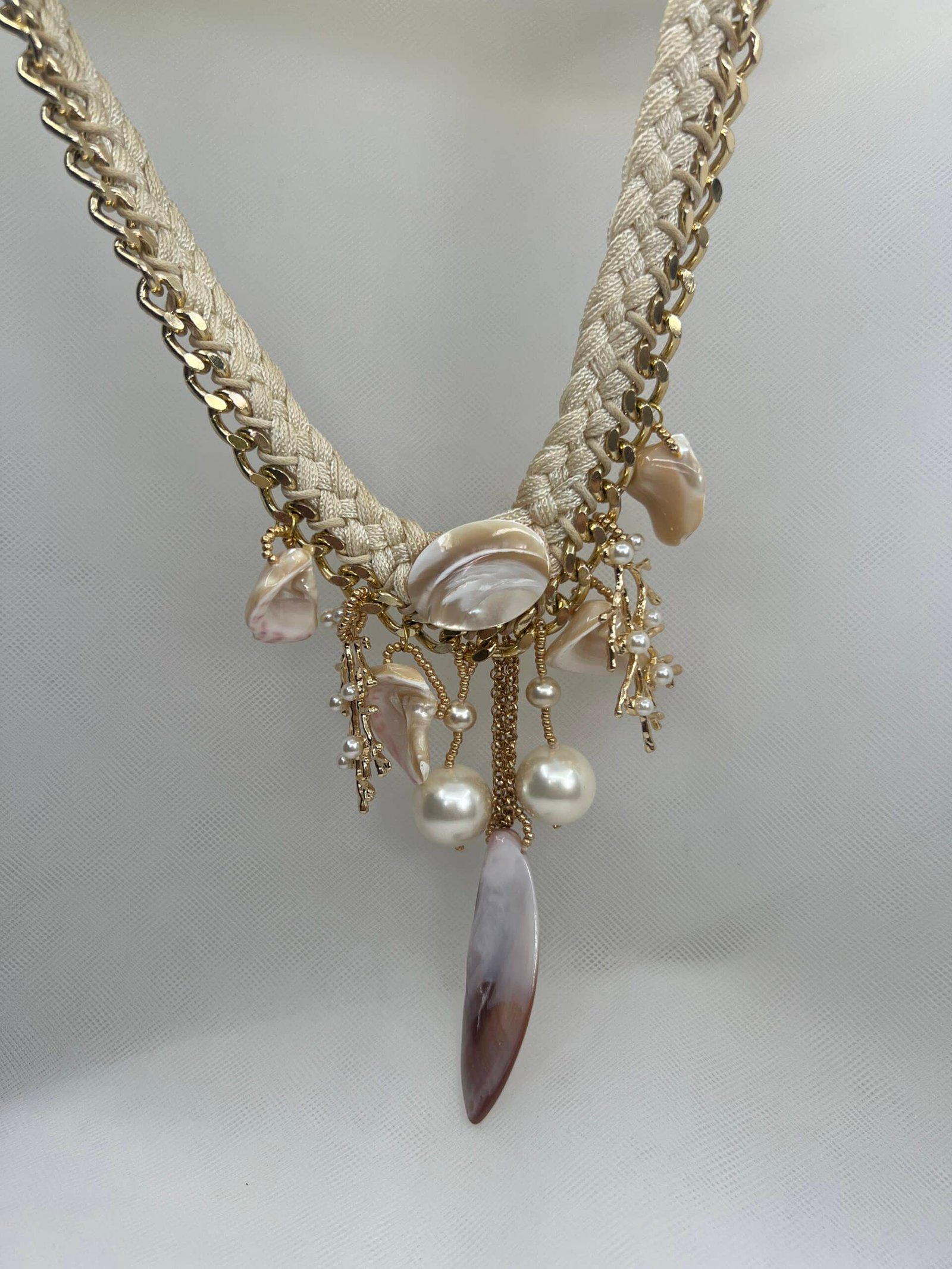Collar de bisuteria con conchas naturales adornos metalicos y perlas.