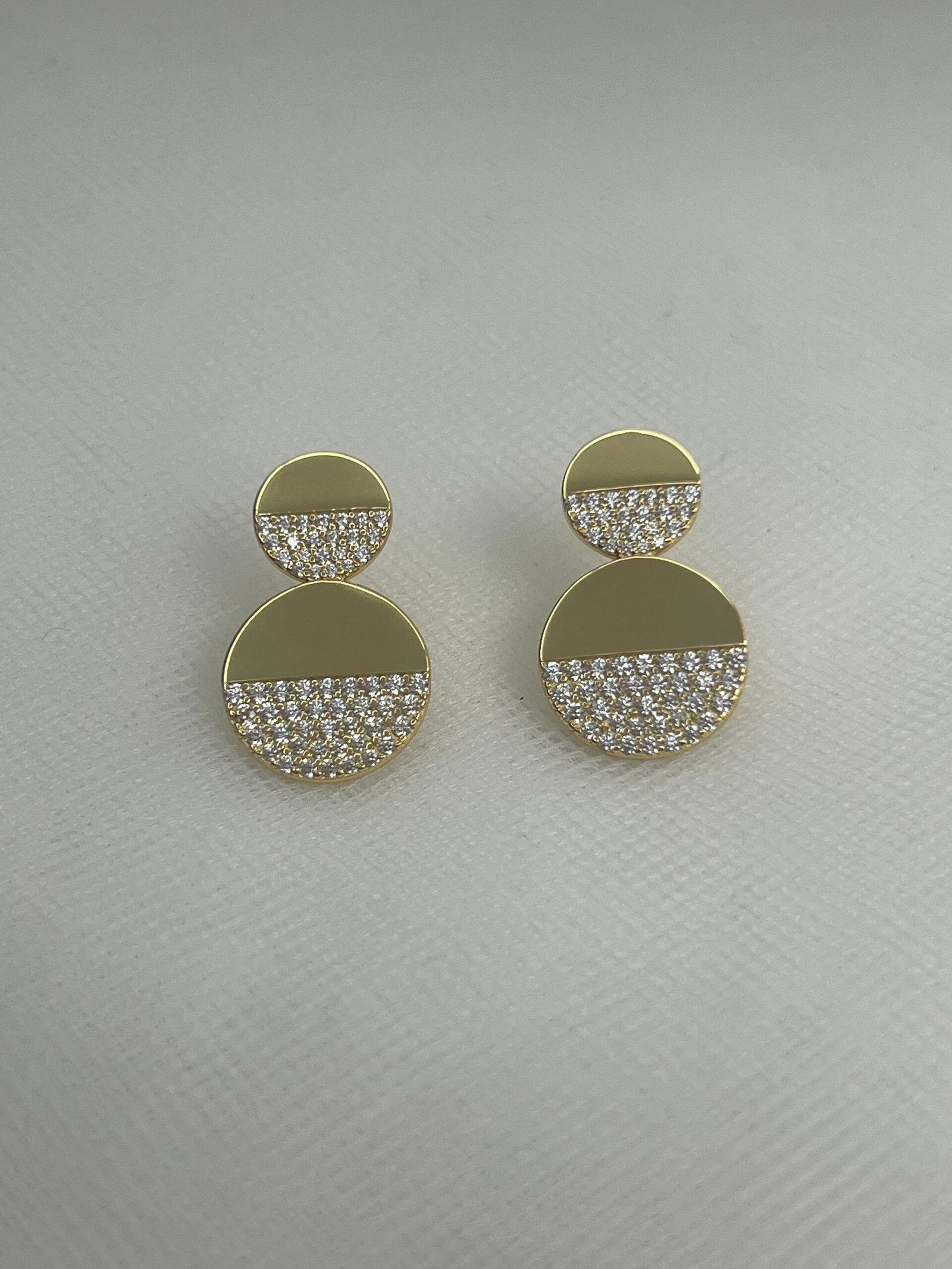 Pendientes de plata chapados en oro amarillo dobles circulos de tamaños distintos con circonitas engastadas.